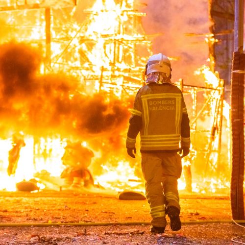 Firefighter with his protective suit working controlling the burning of a Falla