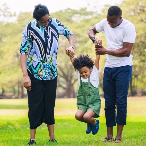 Happy African American family life concept. Parents and little boy enjoyed themselves together.